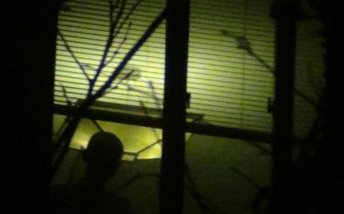 Liu Xia at her apartment window, Beijing, August 2012. Photo by Hu Jia.