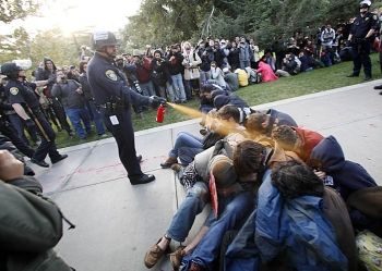 Still from video of Lt. John Pike pepper-spraying peaceful protesters at UC Davis, 11/18/11
