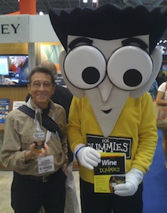 A. D. Coleman hoists a brewski with the "Wine for Dummies" mascot, BookExpo America, Javits Center, NY, May2 29, 2013. Photographer unknown. Copyright 2013 by A. D. Coleman.