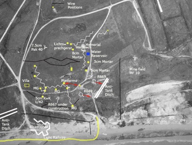 Aerial photo of WN62 with notations showing features of the defense. (Image and notations from ATLANTIKWALL.CO.UK). The two features labelled “R669” (center, just to the left of the anti-tank ditch) were newly built bunkers housing the 75mm field artillery pieces that covered the beaching site of LCI(L)-94. The LCI beached at the right edge of this photo, only about 400 yards from the two guns. Zaloga identifies these two bunkers as Type R612 (vice R669). The upper bunker is now the base for the memorial to the 5th Engineer Special Brigade.